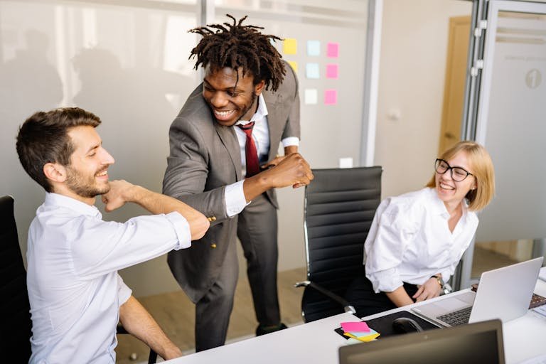 A Boss Touching Elbows with His Employee