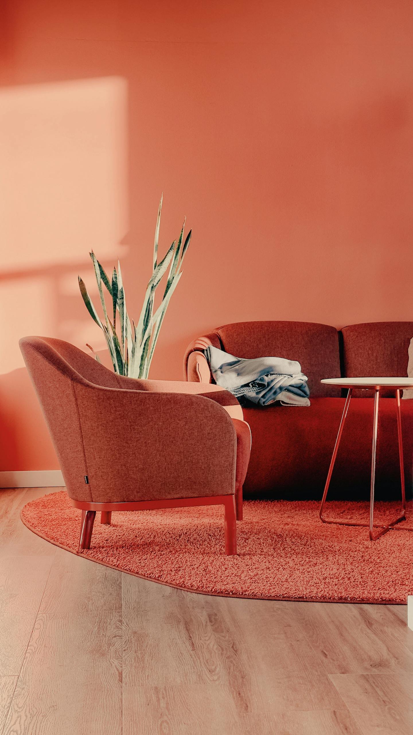 A living room with a red couch and a coffee table